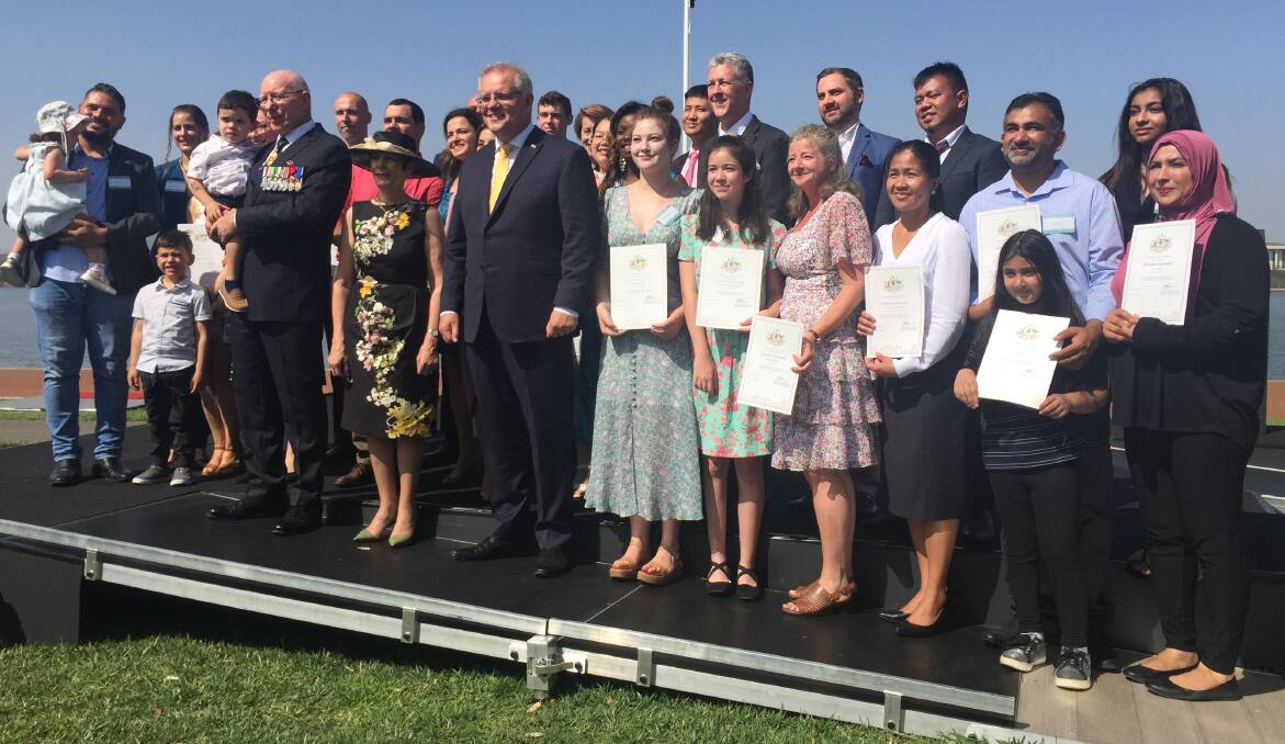 The 29 new citizens who took part in Sunday's ceremony in Canberra, with Governor-General David Hurley, his wife Linda Hurley, and Prime Minister Scott Morrison in front. Picture: Kirsten Lawson