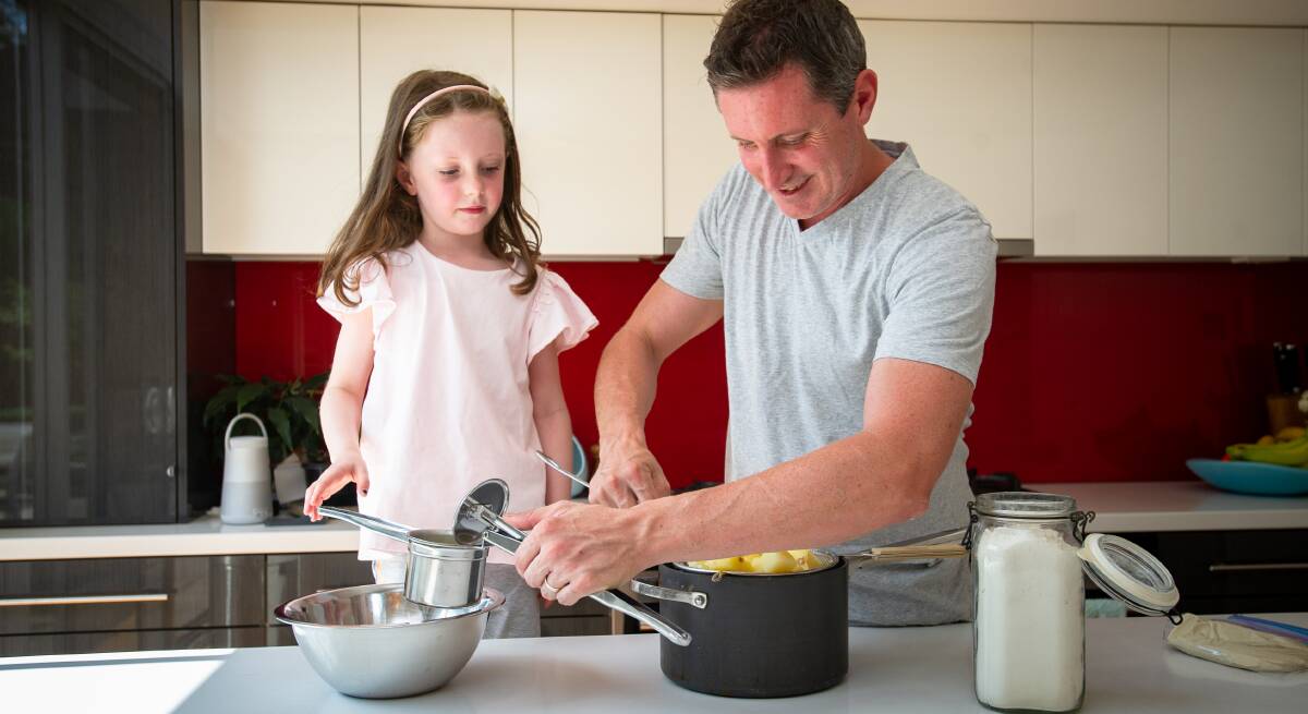 Chef and restaurateur Ben Willis, with daughter Chloe, 6, in the kitchen at home with his restaurant closed. He is unsure how the details of the new JobKeeper payment might play out for his staff. Picture: Elesa Kurtz