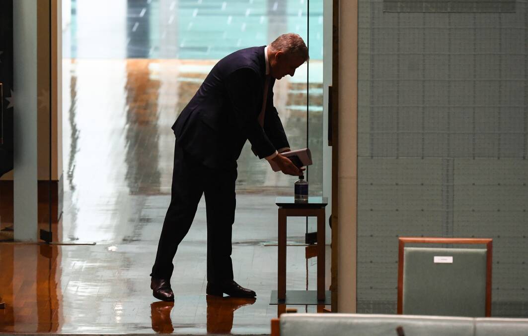 Michael McCormack uses the hand sanitiser on his way into the Chamber on Wednesday. Picture: Lukas Coch