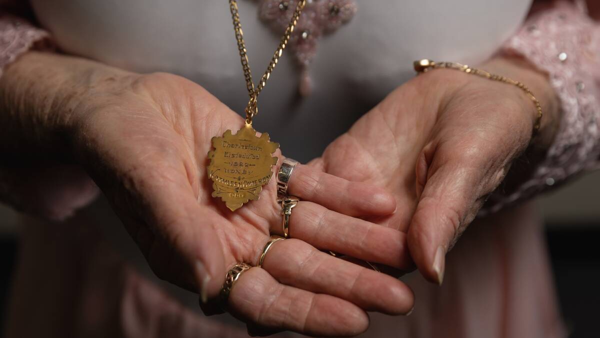 Helen Crampton holding an eisteddfod badge won by her mother as a teenager. Picture by Marina Neil