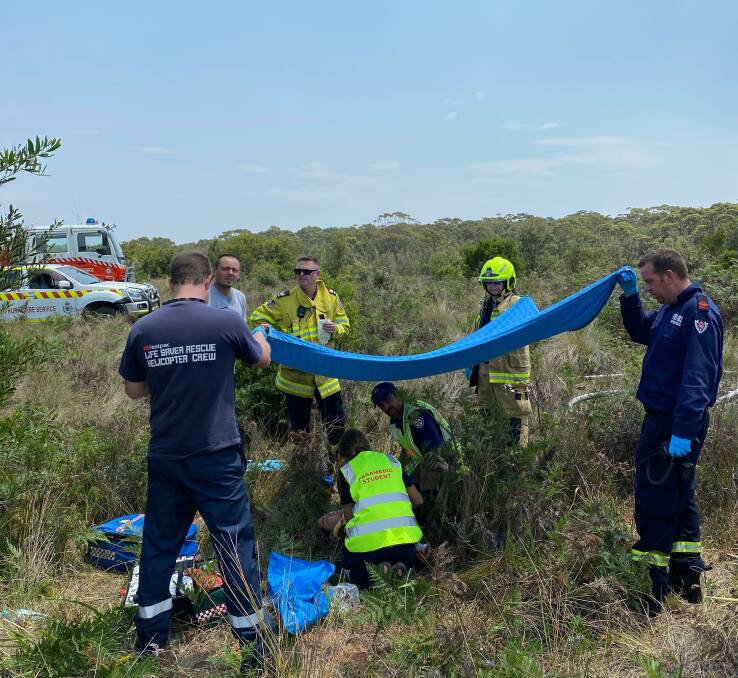 Emergency crews attend to the occupants involved in a plane crash near Moruya Airport.