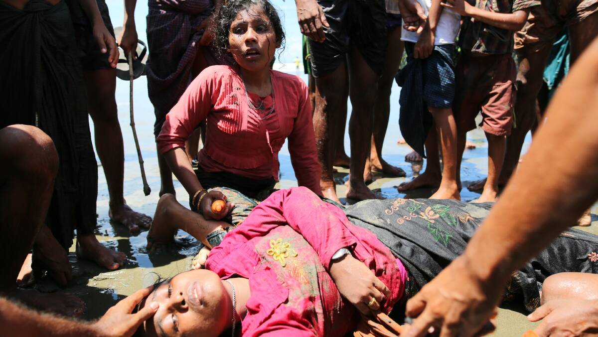 A Rohingya woman lies unconscious on the shore of Bay of Bangal after the boat she was traveling in capsized. Picture Getty Images