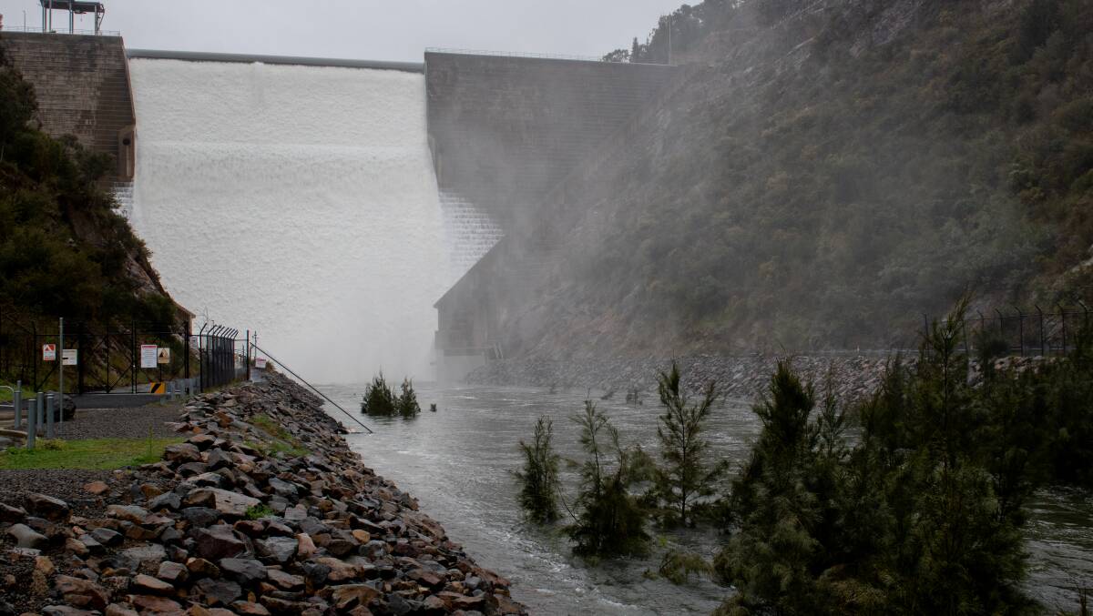Water flows over the Cotter Dam. Picture by Elesa Kurtz