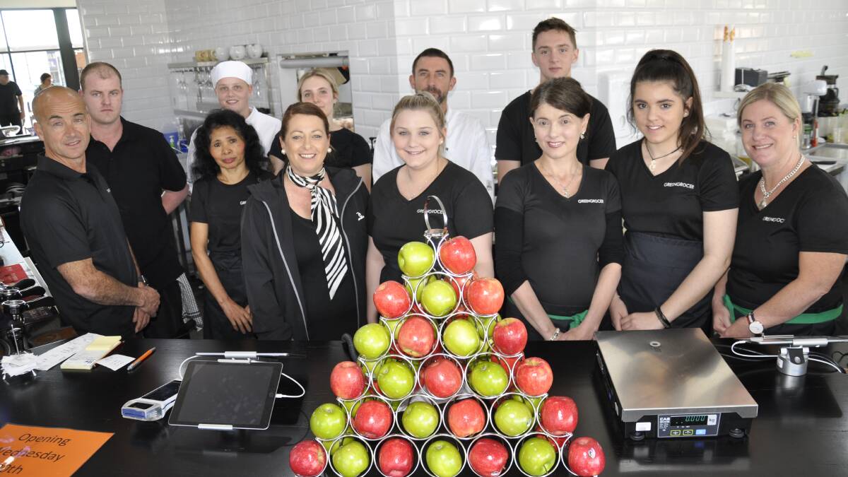 Con Toparis, left, and wife Lana, wearing scarf, with Greengrocer staff, at the reopening of the cafe after a fire. Picture file
