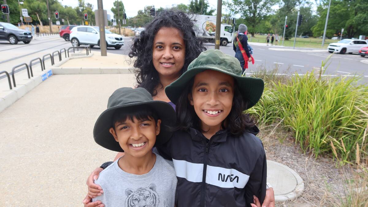 Neil Basu, Tahseen Kamal and Abyan Eiad watched the Summernats city cruise on Northbourne. Picture by Steve Evans