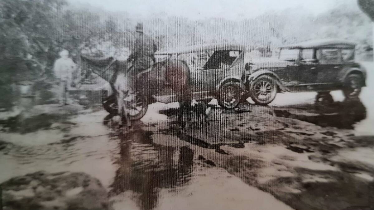 Neville and Hugh Macken crossing Currarong creek at low tide, before the bridge was built in the early-to-mid 1930s. Picture: Supplied