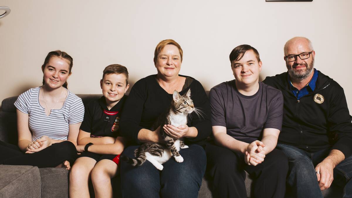 Twins (left Jazmyn and Ashton Volmari will return to school today, among the last cohort in ACT to do so. Pictured with mother Renea, Cookie the cat, brother Cody, and father Jason. Picture: Jamila Toderas