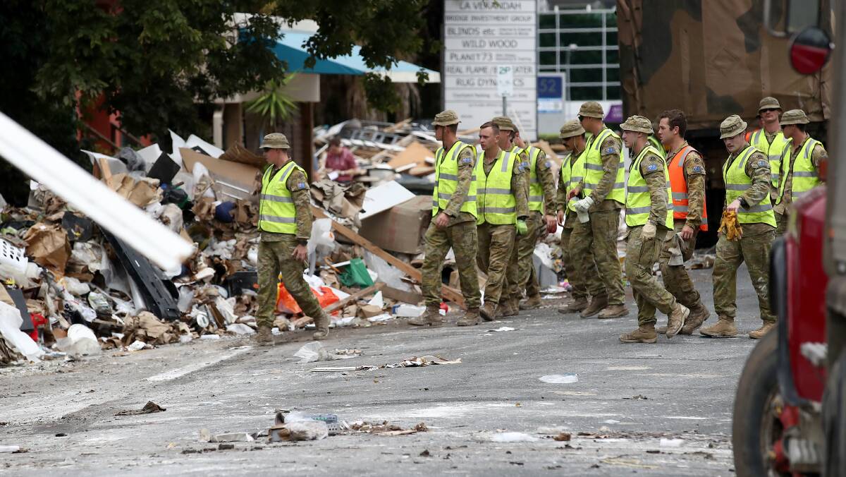Defence Force members clean up flood damage in Queensland. Picture Getty Images