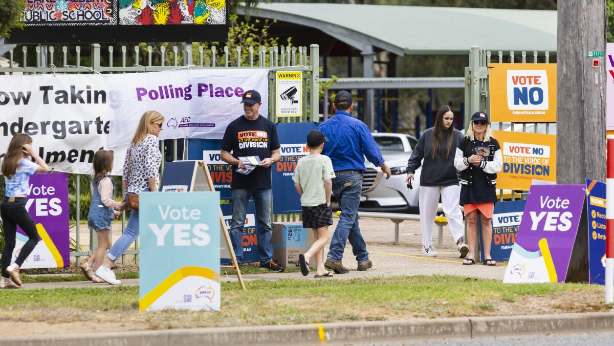 Families head to a polling station ahead of last year's Voice referendum. Picture by Ash Smith