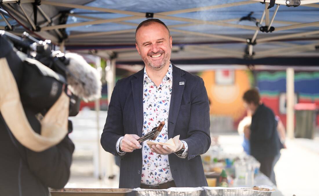 Andrew Barr serves up a democracy sausage on election day. Picture: Matt Loxton