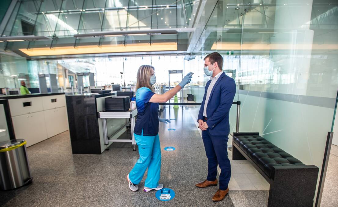 Temperature screening of all passengers and staff commence at Canberra Airport.
Mitchell Sewter has his temperature checked by a nurse. Picture: Karleen Minney