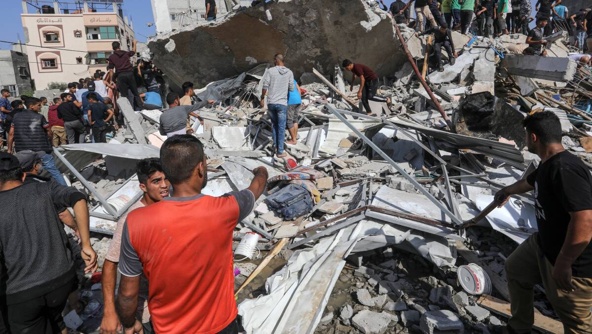 Palestinians inspect their house, after it was destroyed by an Israeli air strike on the city of Rafah. Picture Shutterstock
