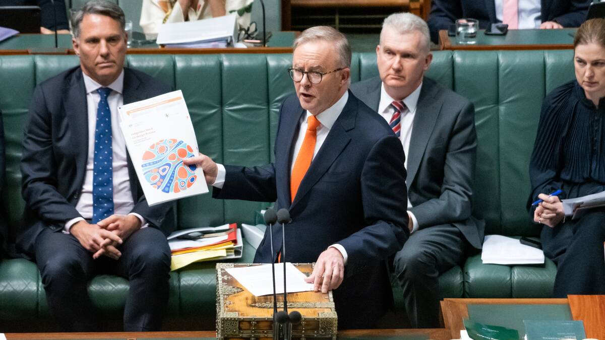 Prime Minister Anthony Albanese with the Indigenous Voice co-design process document in the House of Representatives. Picture by Elesa Kurtz