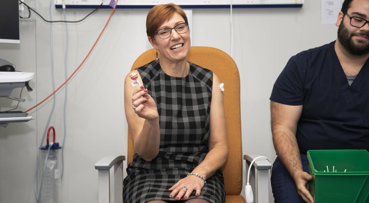 ACT Health Minister Rachel Stephen-Smith gets a lollipop after receiving her Covid jab. Picture: Keegan Carrol