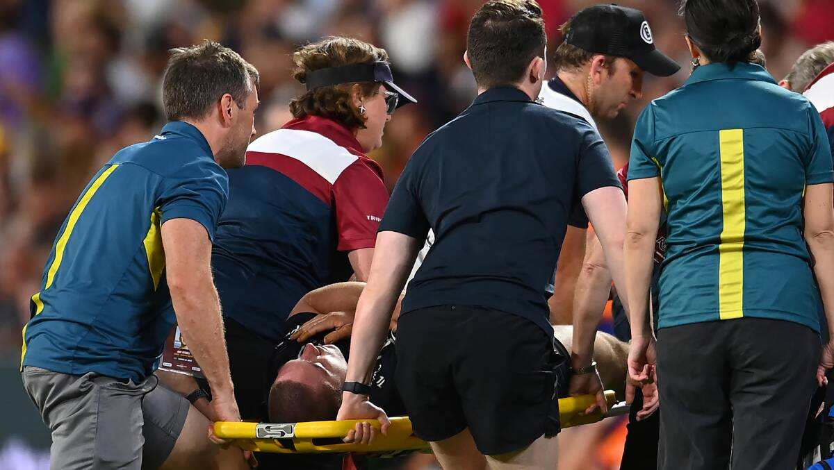 Lachlan Lonergan is stretchered from the field. Picture Getty Images
