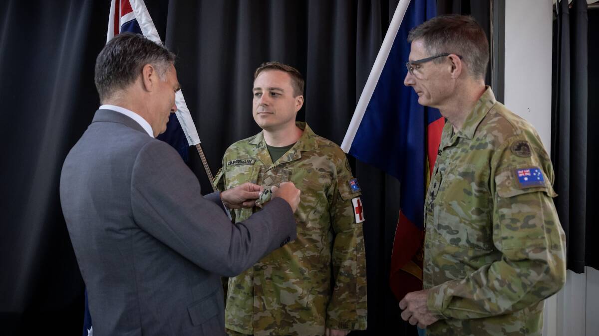 Defence Minister Richard Marles promotes Lieutenant-Colonel Peter Zimmermann with Chief of the Defence Force General Angus Campbell. Picture Defence Images
