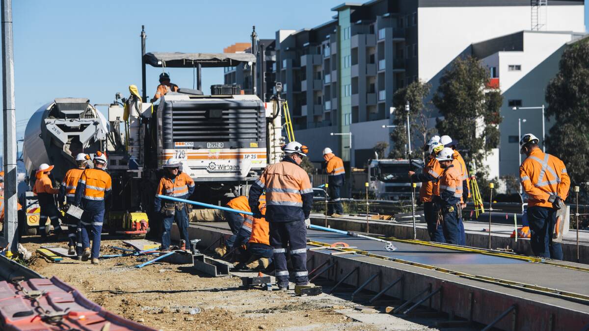 Workers laying the slap for the light rail line on Flemington Road during construction. Picture: Rohan Thomson