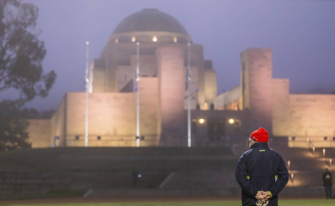 A man is seen silently observing the Anzac Day dawn service at the Australian War Memorial. Picture: Sitthixay Ditthavong