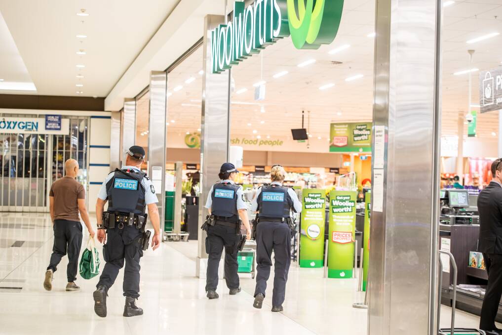 A police presence at Majura Park Woolworths to maintain some calm. Picture: Karleen Minney