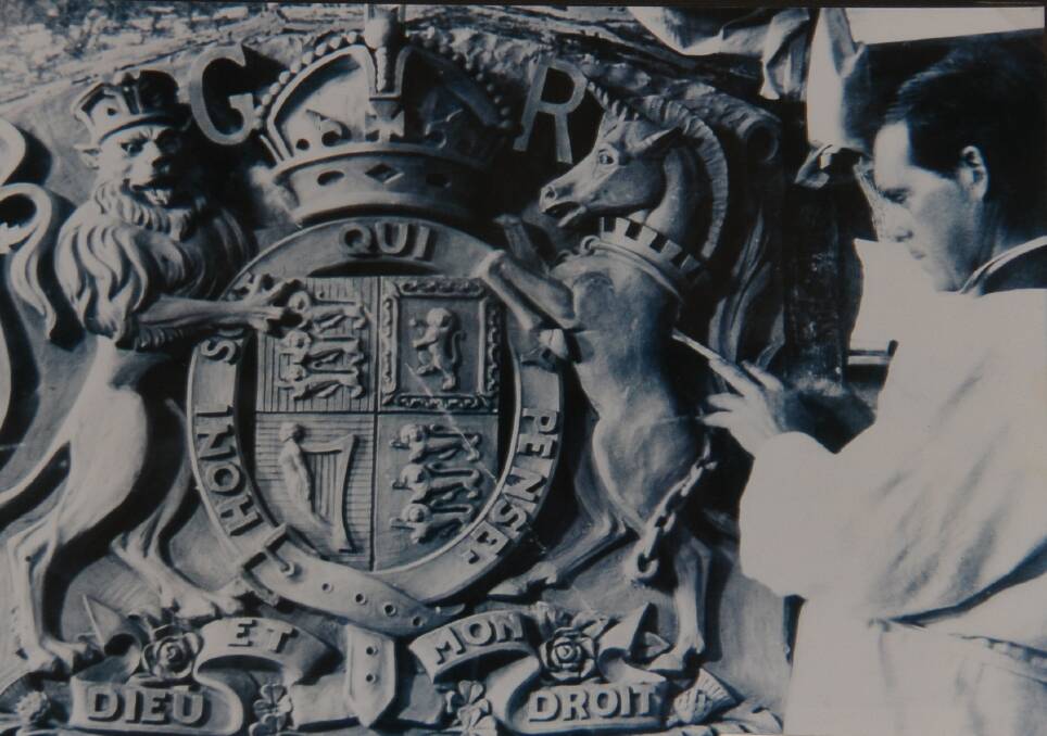 John Grant applying the finishing touches to the Royal Coat of Arms for the Preston Court House in Melbourne. Picture: Courtesy of Dr Lachlan Grant