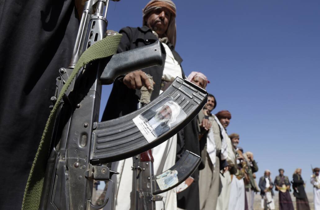 Men with AK47s gather on the outskirts of Sanaa, Yemen following US-UK attacks. Picture Getty Images