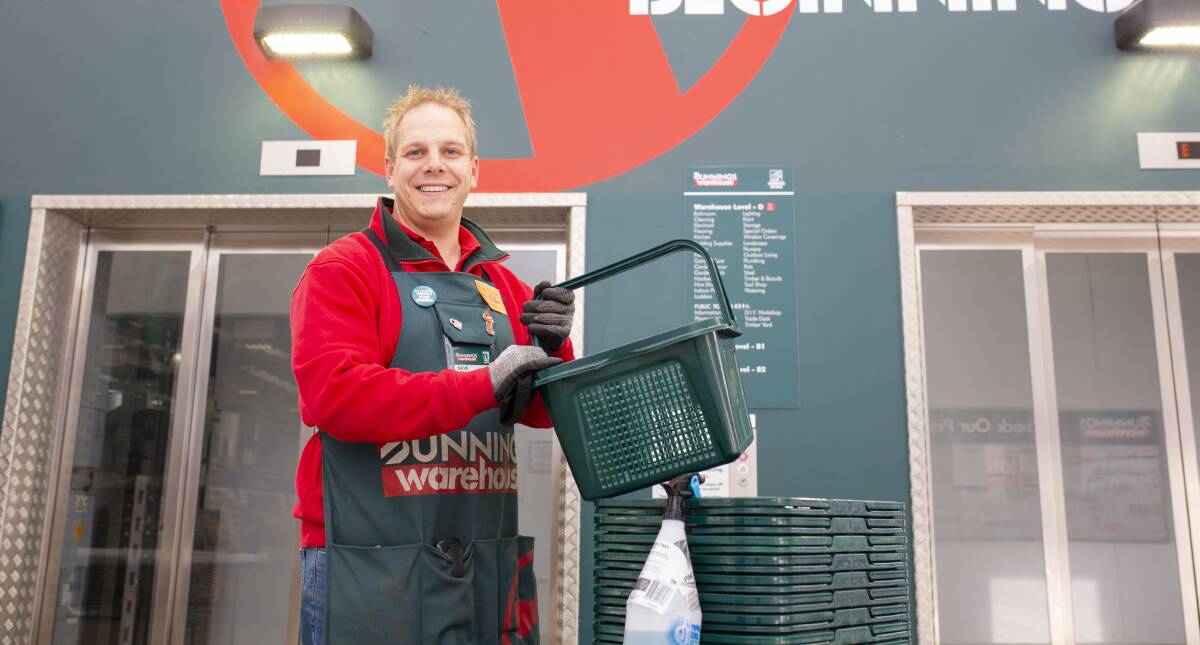 Bunnings Gungahlin complex manager David Lammers disinfecting baskets. Picture: Jamila Toderas