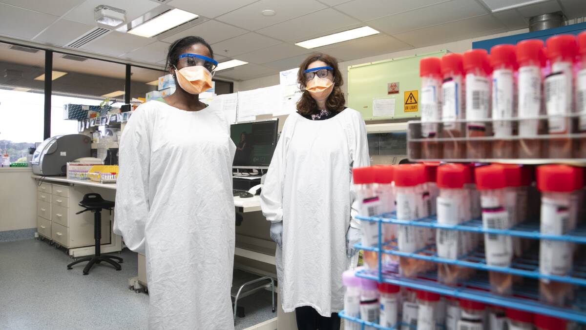 Canberra Health Services molecular scientist Jenny Ridgway and acting lab manager Lynette Chairuka processing ACT COVID tests. Picture: Keegan Carroll