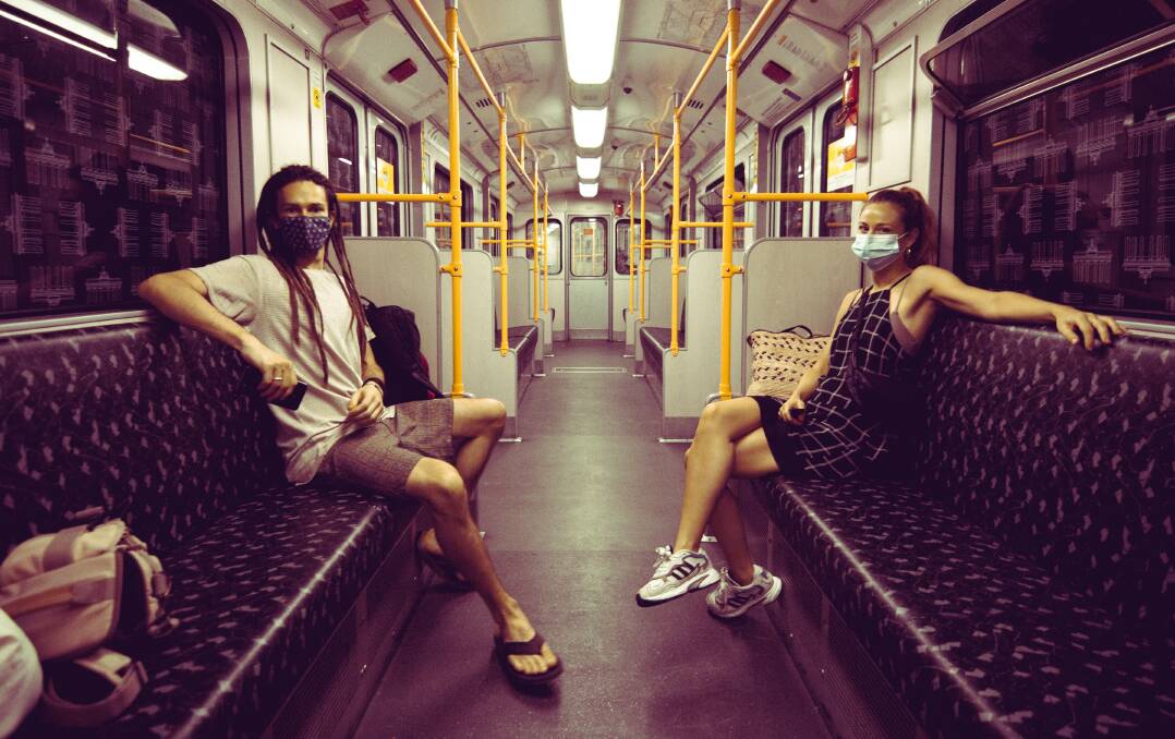 Michael with the couple's friend Nike on the train in Berlin. Nike was also due to travel back to Australia but is now stuck in Amsterdam. Picture: Supplied