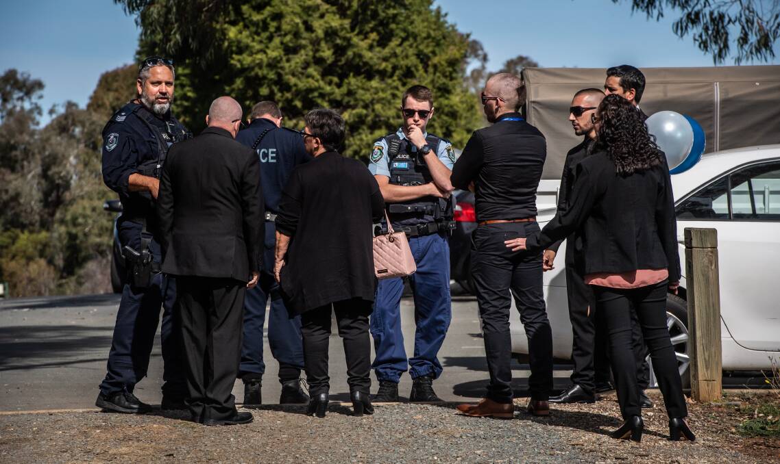 Mourners try and reason with police about a gathering at a Queanbeyan funeral. Picture: Karleen Minney