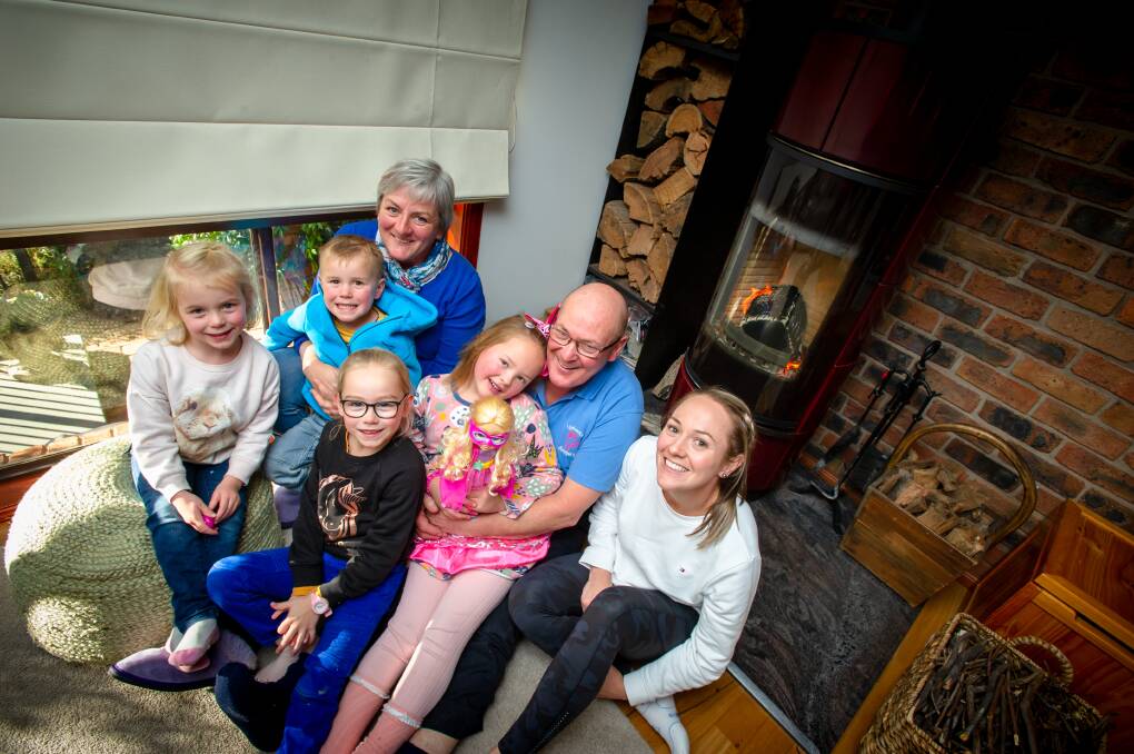 Peter Lindbeck with wife, Ruth, and, Molly French, 4, Reggie French, 3, Edith French, 6, Ruby Wigg, 6, and Kate Wigg enjoying the warmth from the wood-burning stove. Picture: Elesa Kurtz