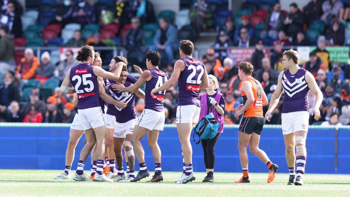 Fremantle Dockers players at Manuka Oval with guernseys emblazoned with Woodside logos. Picture by Sitthixay Ditthavong