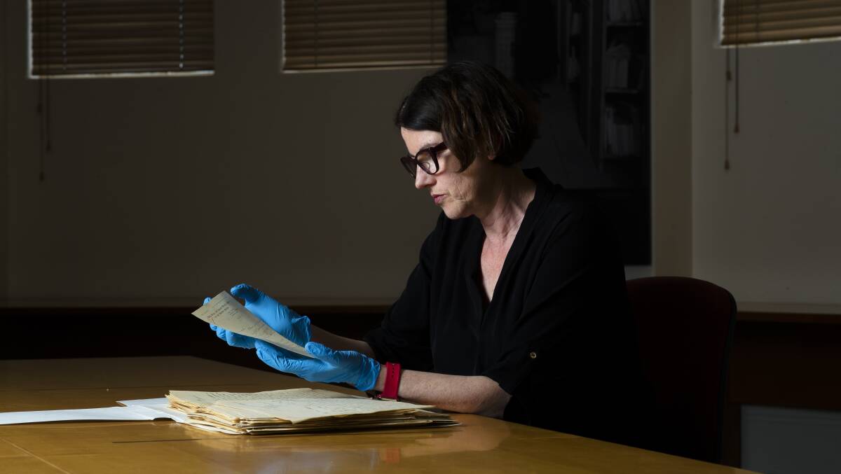 Head of the Australian War Memorial's research centre, Robyn Van Dyk, holds a letter from the First World War. Picture by Keegan Carroll