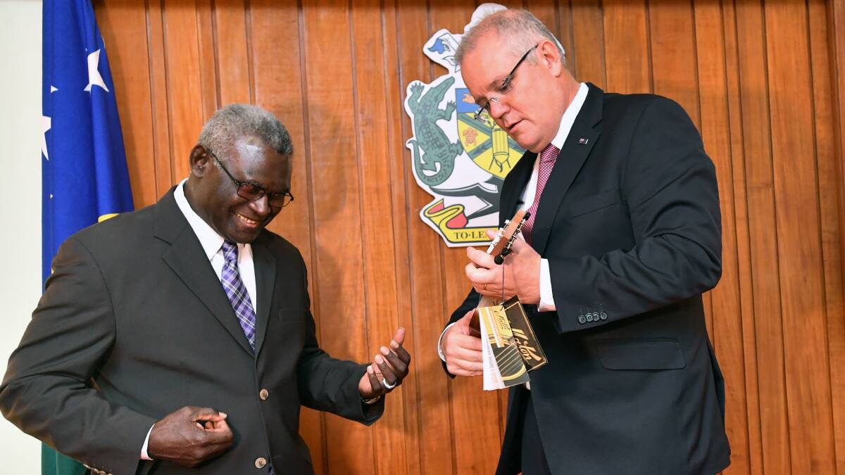Scott Morrison presents Solomon Islands Prime Minister Manasseh Sogavare with a ukulele on a 2019 visit. Picture: AAP