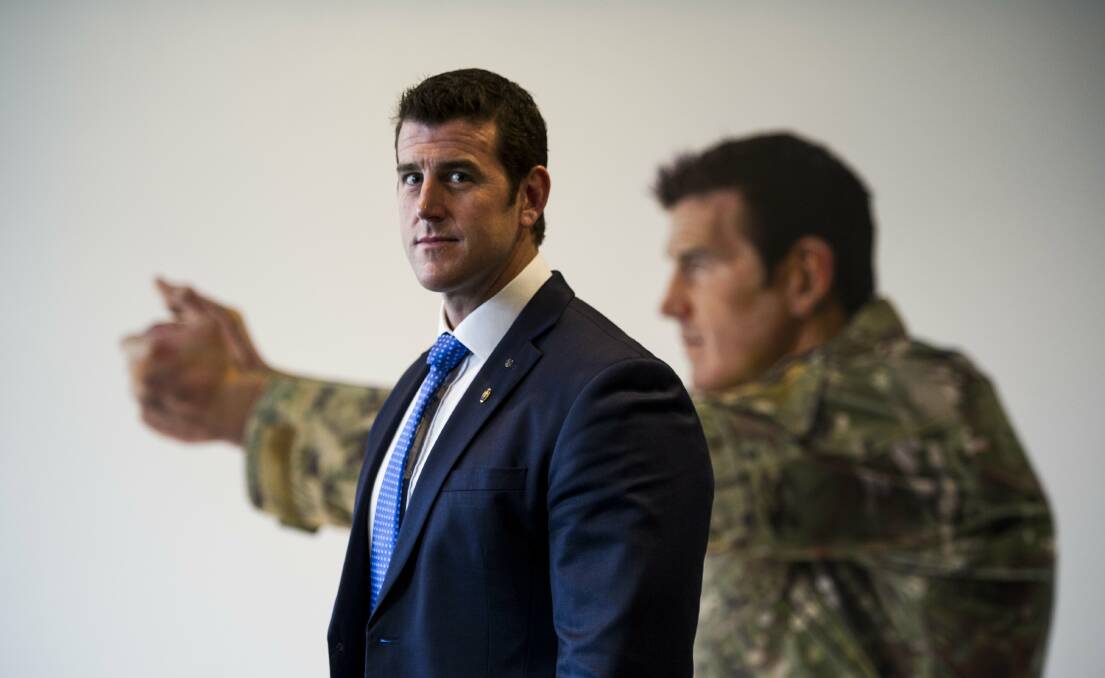 Ben Roberts-Smith in front of a portrait in the Australian War Memorial. Picture by Jay Cronan