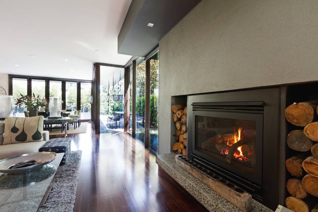 COMFORT AND CONVENIENCE: With some simple styling tricks, you can still get the warmth you need from gas and electric fireplaces without losing the ambience and comforting feel of the room. Photo: Shutterstock