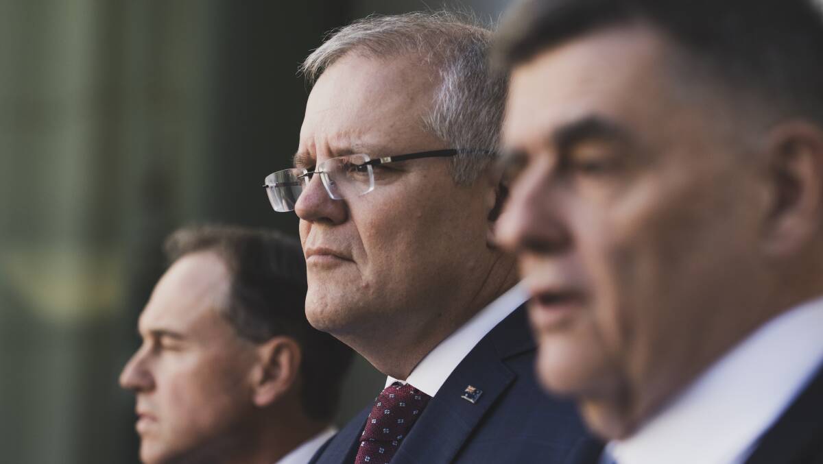 Former prime minister Scott Morrison with then health minister Greg Hunt (left) and chief medical officer Brendan Murphy (right) during the early days of the COVID-19 pandemic. Picture by Dion Georgopoulos