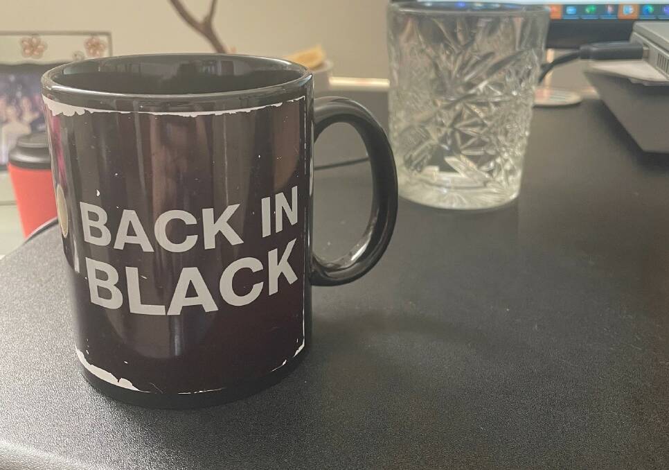 The Back in Black mugs have seen better days. Picture by Mark Kenny