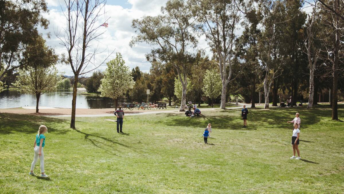 People gather at Yerrabi Pond District Park in Gungahlin for picnics and exercise. Picture: Dion Georgopoulos