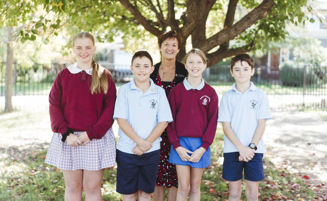 At Rosary Primary School in Watson Essie Brady, Joe Garreffa, Principal Vicky Van Der Sander, Kiera Arthur, and Sam Flynn appreciated being able to mark the occasion in person. Picture: Dion Georgopoulos