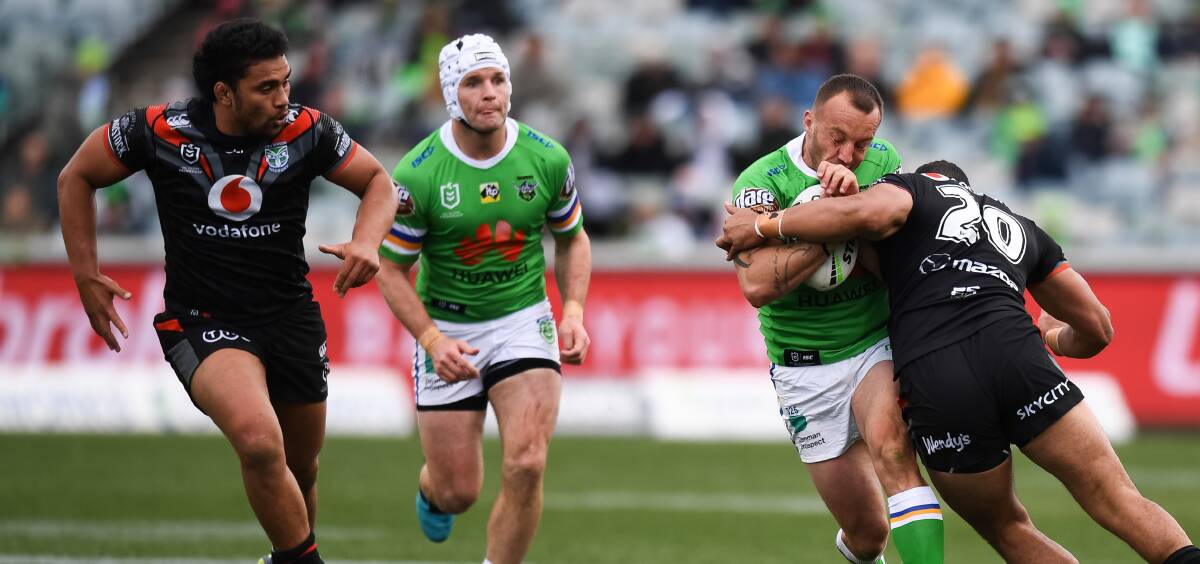 Raiders co-captain Josh Hodgson takes his hat off to the Warriors. Picture: NRL Imagery