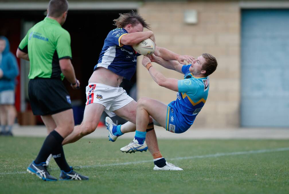 Bushranger Jordan Martin steamrolls Warrior Brandon Withers on his way to a try. Picture: Sitthixay Ditthavong