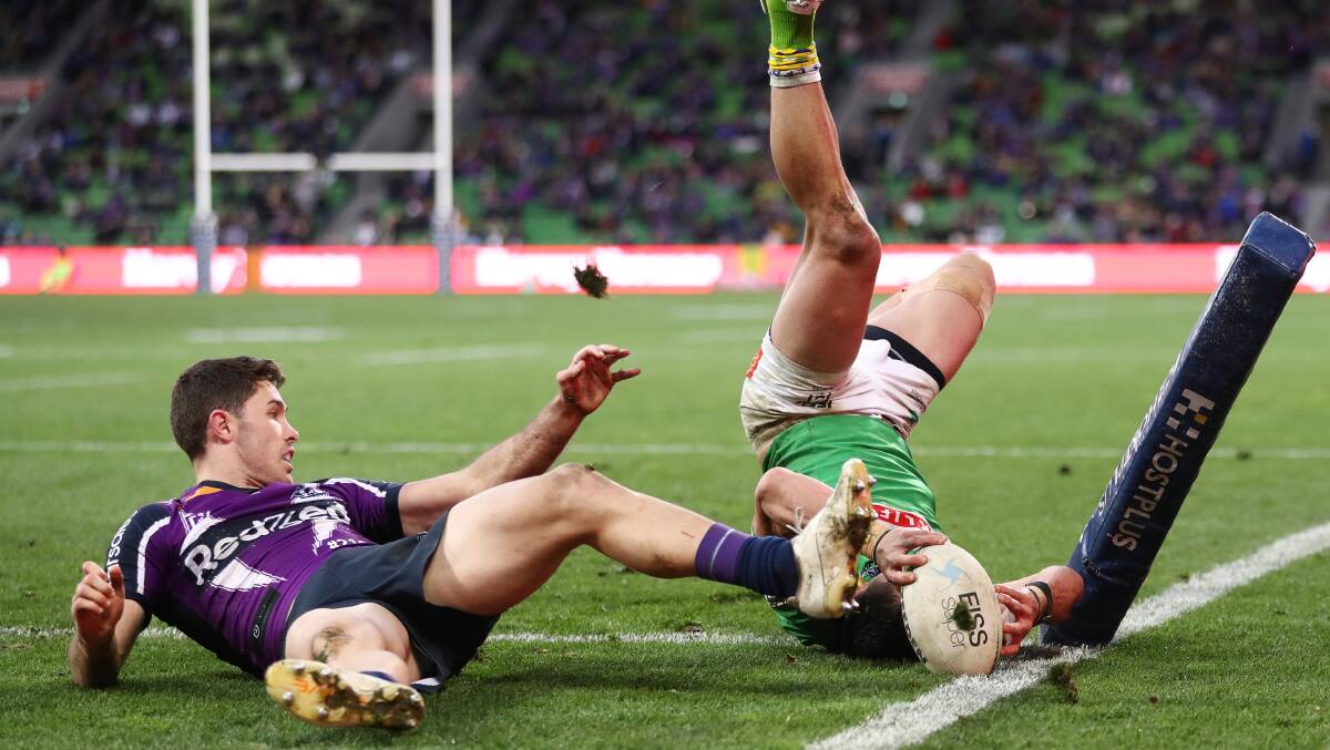 Raiders winger Jordan Rapana, above, almost scores a brilliant try. Storm winger Nick Meaney scores the Storm's opener. Picture: Getty Images Pictures: Getty Images