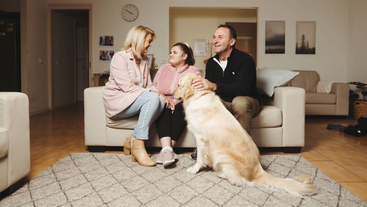Member of the Order of Australia recipient Ricky Stuart relaxes with wife Kaylie, daughter Emma and Kosmo. Picture: Dion Georgopoulos