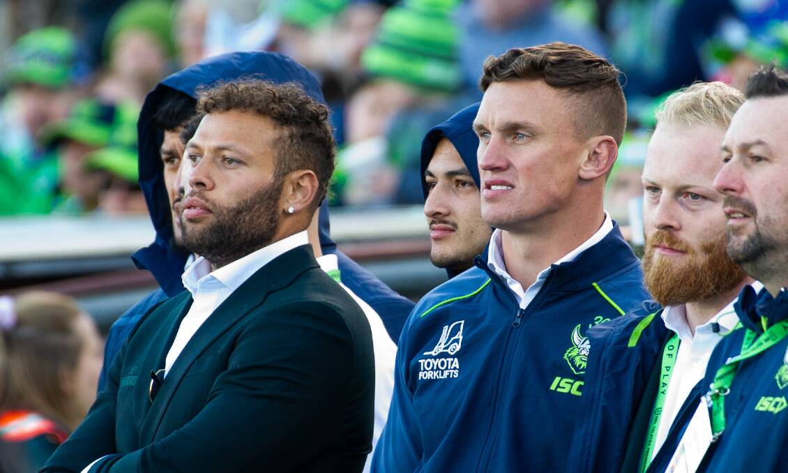 Sebastian Kris, left, watches the Raiders' round 25 game against Canterbury while out with a hamstring injury. Picture by Elesa Kurtz
