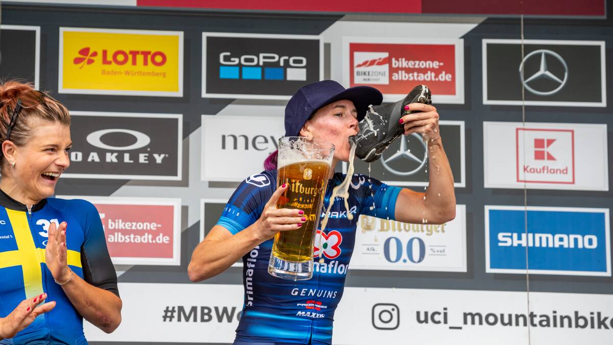 Two wins in three days meant Canberra mountain biker Bec McConnell needed a well-earned shoey. Picture: Getty Images