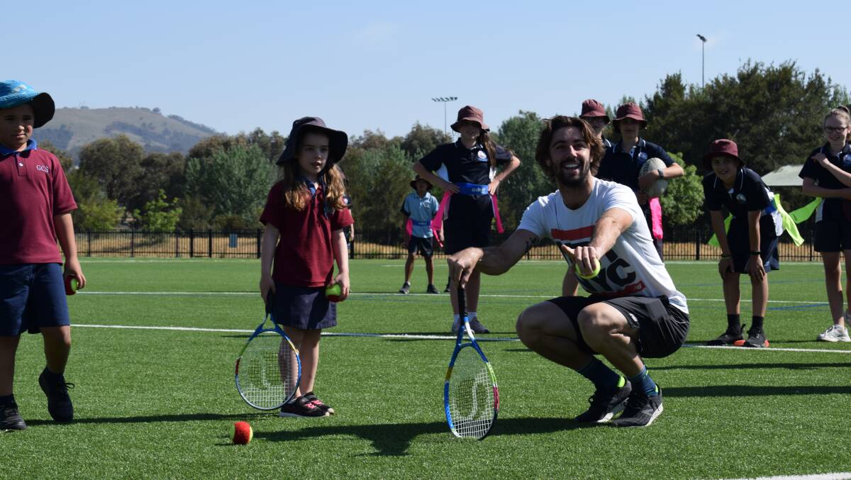 Jordan Thompson leads tennis activities with Gold Creek School students. Picture: Tennis ACT