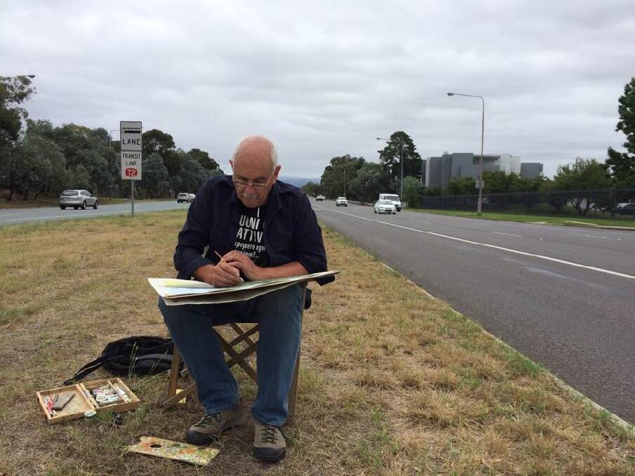 Canberra artist Christopher Oates works on a painting in the middle of six-lane Adelaide Avenue. Photo: Megan Doherty