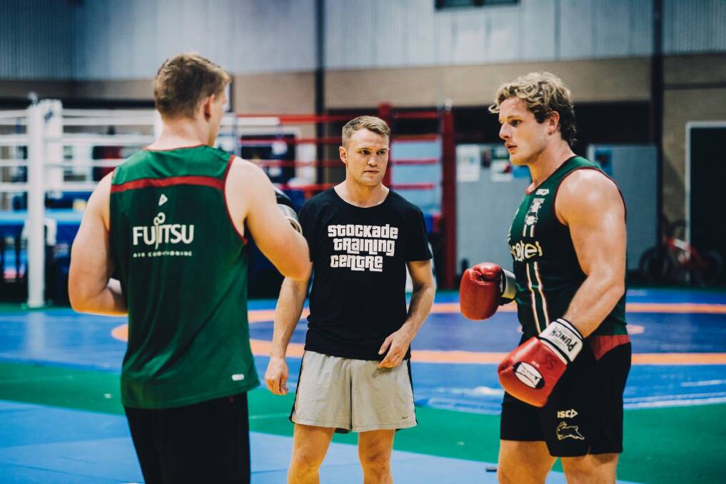 Canberra boxer Dave Toussaint is doing a boxing session with South Sydney Rabbitohs players at the AIS. Dave Toussaint with Rabbitohs George Burgess. Photo: Jamila Toderas Photo: Jamila Toderas