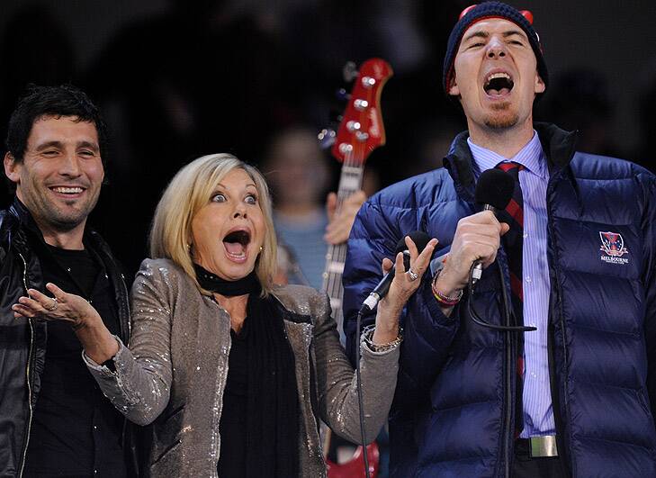 Playful ... Jim Stynes sings along with Olivia Newton John and  Russell Robertson before a Melbourne vs Carlton game in May last year. Photo:  Sebastian Costanzo