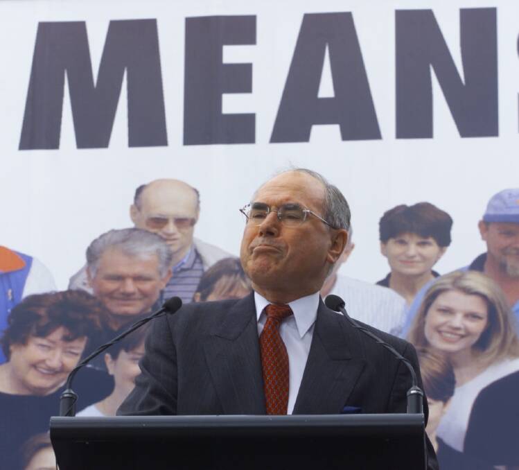 John Howard stands next to a 'cheaper diesel means cheaper goods' sign. Photo: Andrew Meares